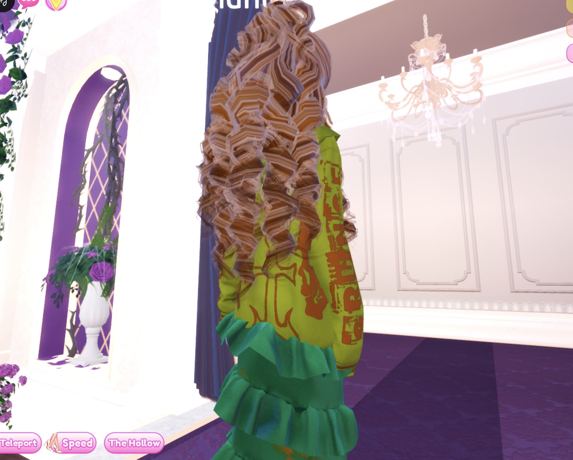 Close side view of the olive jacket with brown lettering under long golden-brown curls, green ruffles below