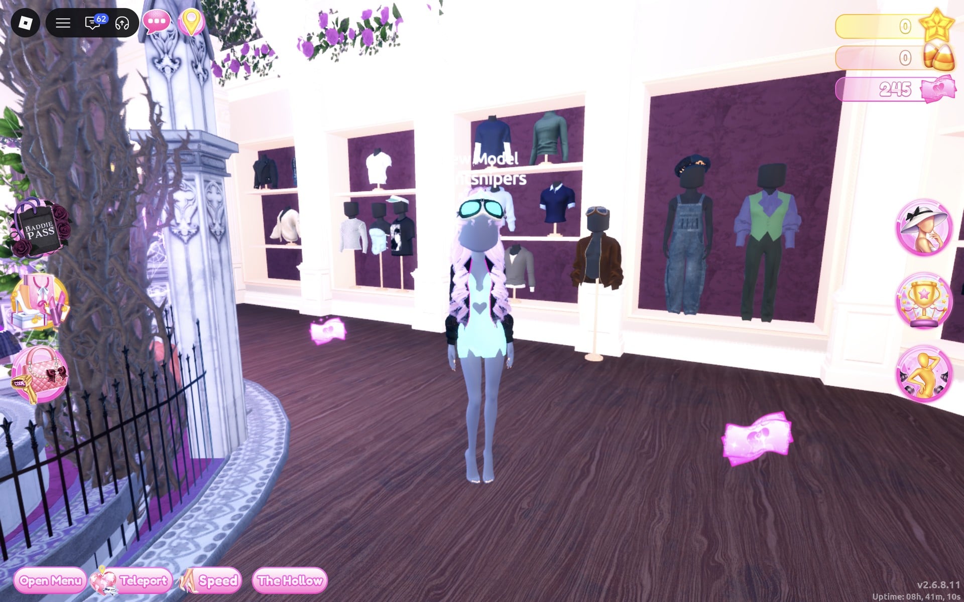 The character wearing the black jacket and glowing cyan goggles over a pale blue heart mini, with lilac curls, by the shirt shelves