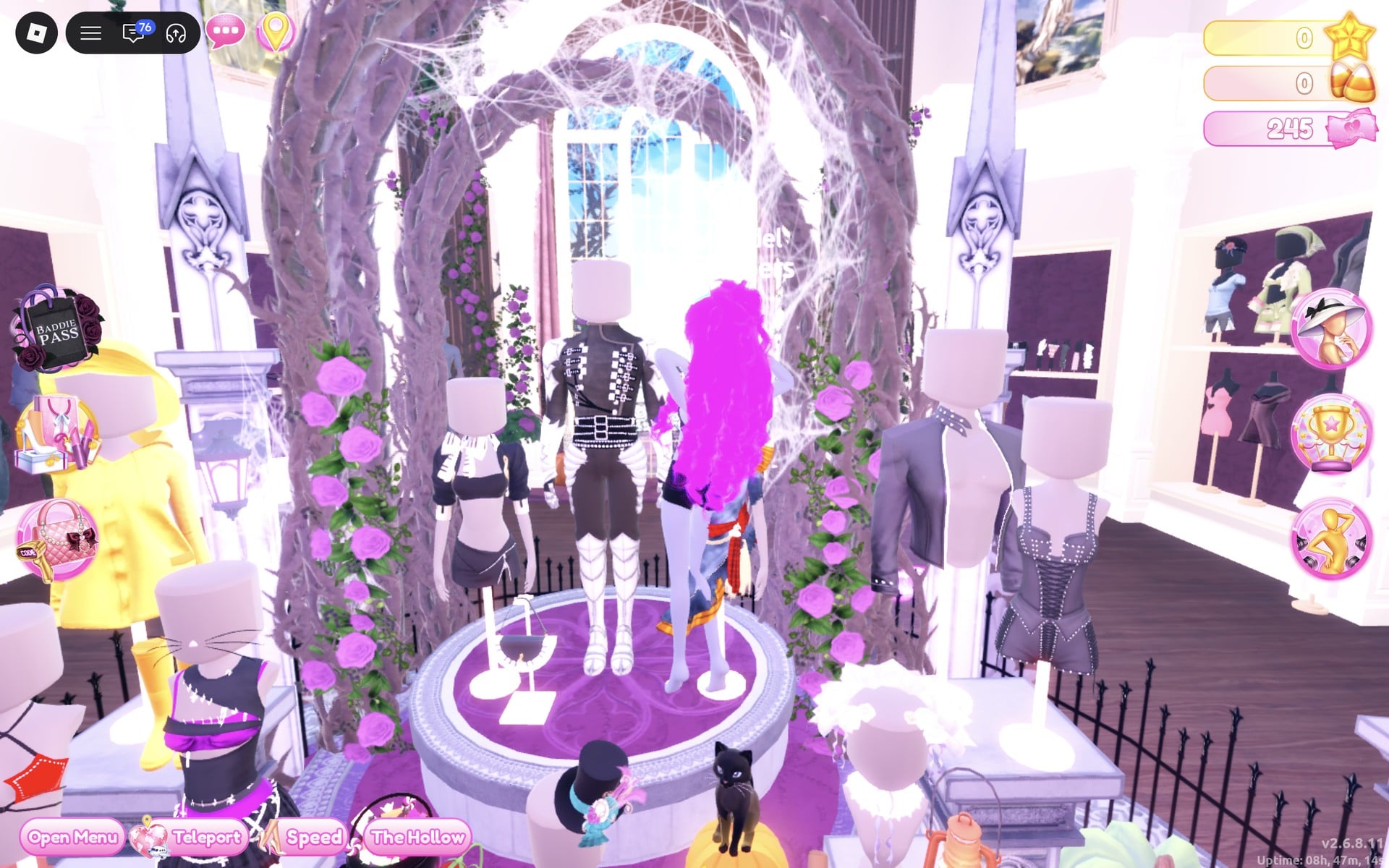 Round raised display under a thorny arch with mannequins, a studded black strap jacket in the centre