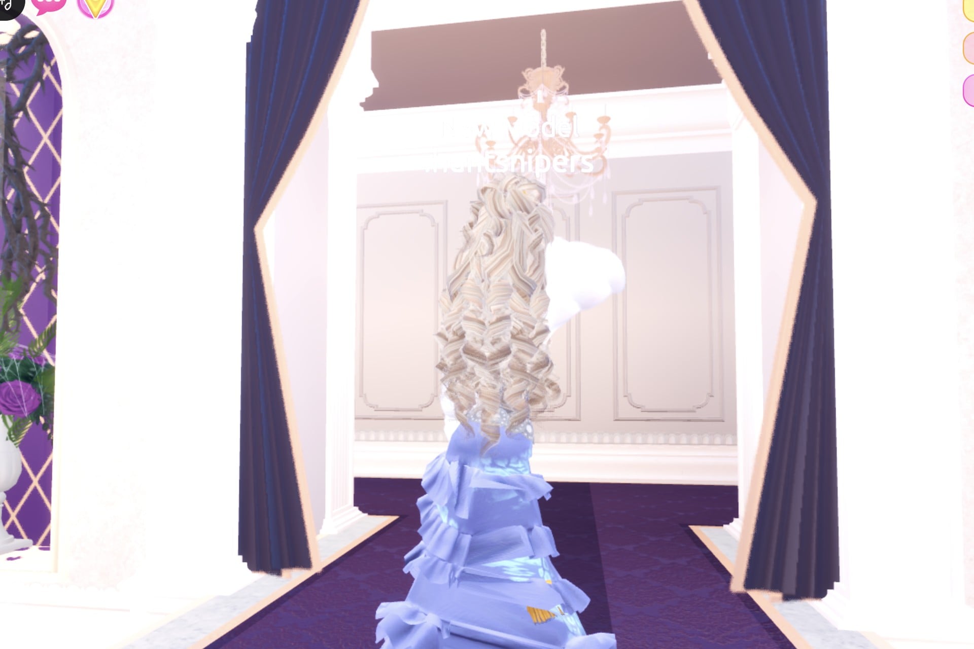 Celestial look from the back: long blonde curls over the white fur jacket and pale blue tiers