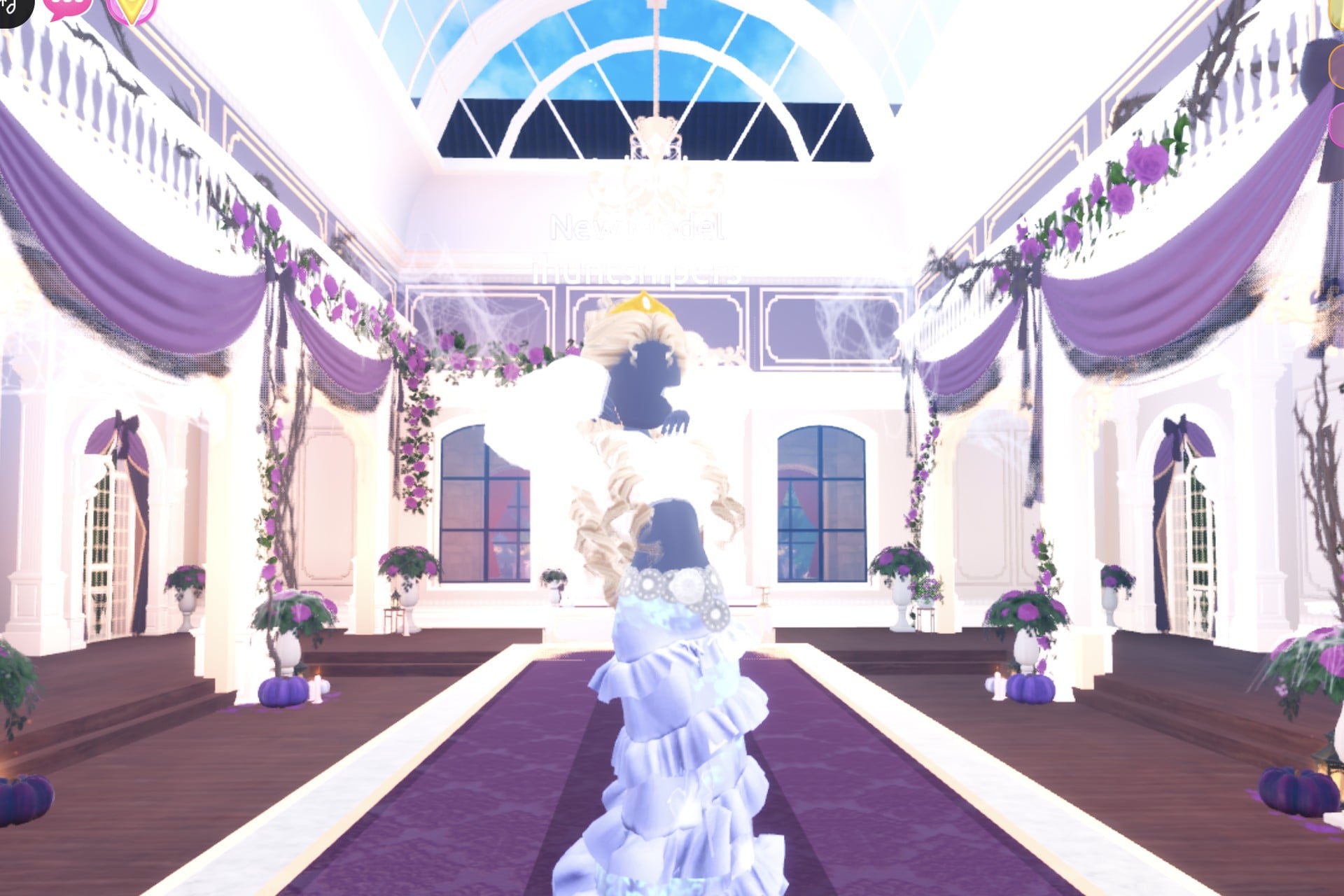 Divine Beings celestial look posed on the Freeplay Runway: pale blue ruffled gown with a glowing hem, white fur jacket, blonde curls and gold crown