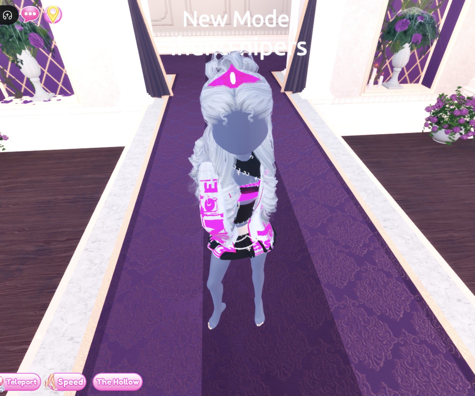 Silver DJ look on the Freeplay Runway in the Shimmer pose: silver jacket with hot pink lettering, black crop top with a pink band, black pleated mini with silver chains, silver curls and a hot pink crown, barefoot