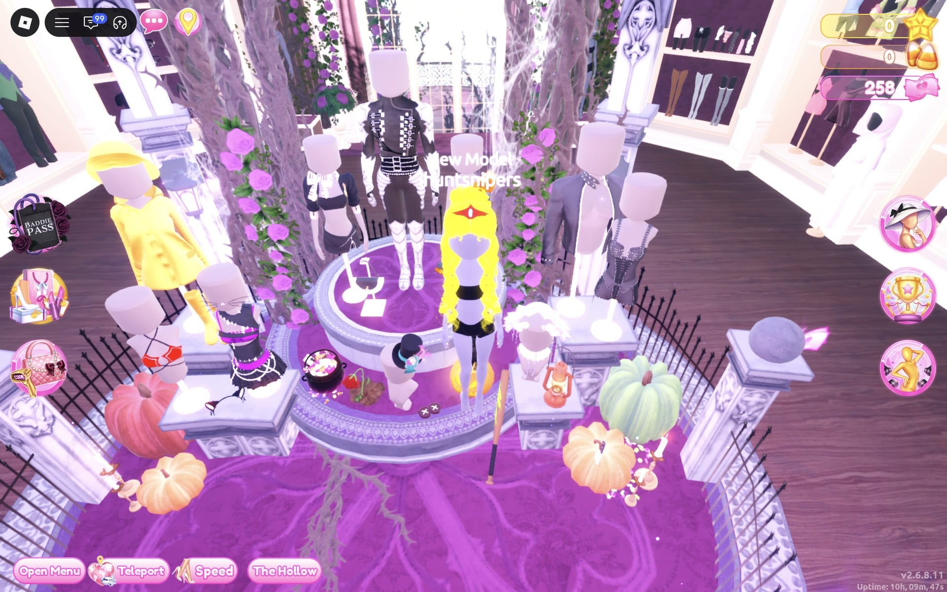 The Halloween display circle: a round fenced podium with thorny trees, pumpkins and mannequins, including a black cropped top and mini left of the centre mannequin and white strap boots on the centre one