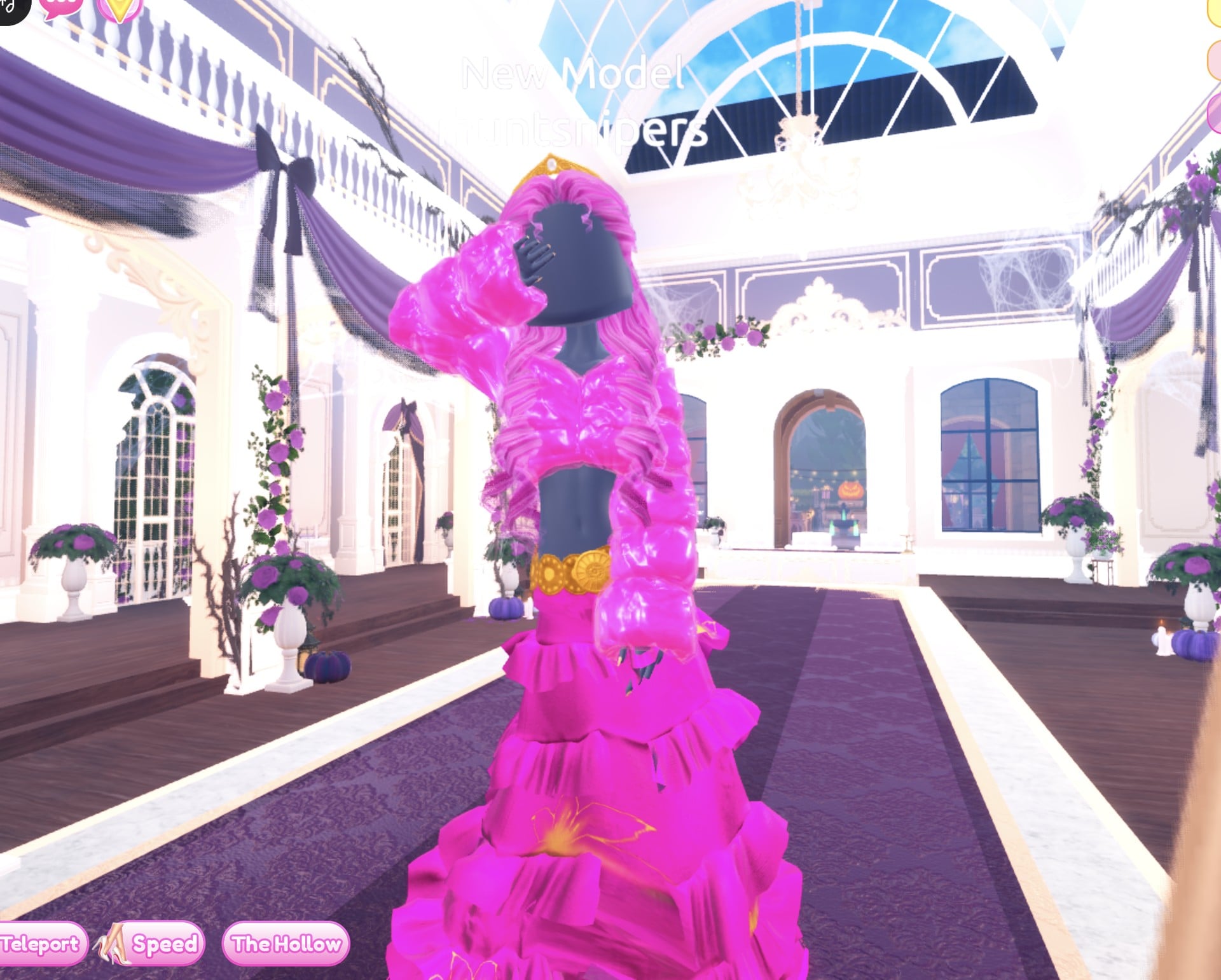 Hot pink pageant Drag look in the Dazzle pose: glittery pink ruffled gown, shiny pink fur jacket, pink curls, gold crown and gold belt