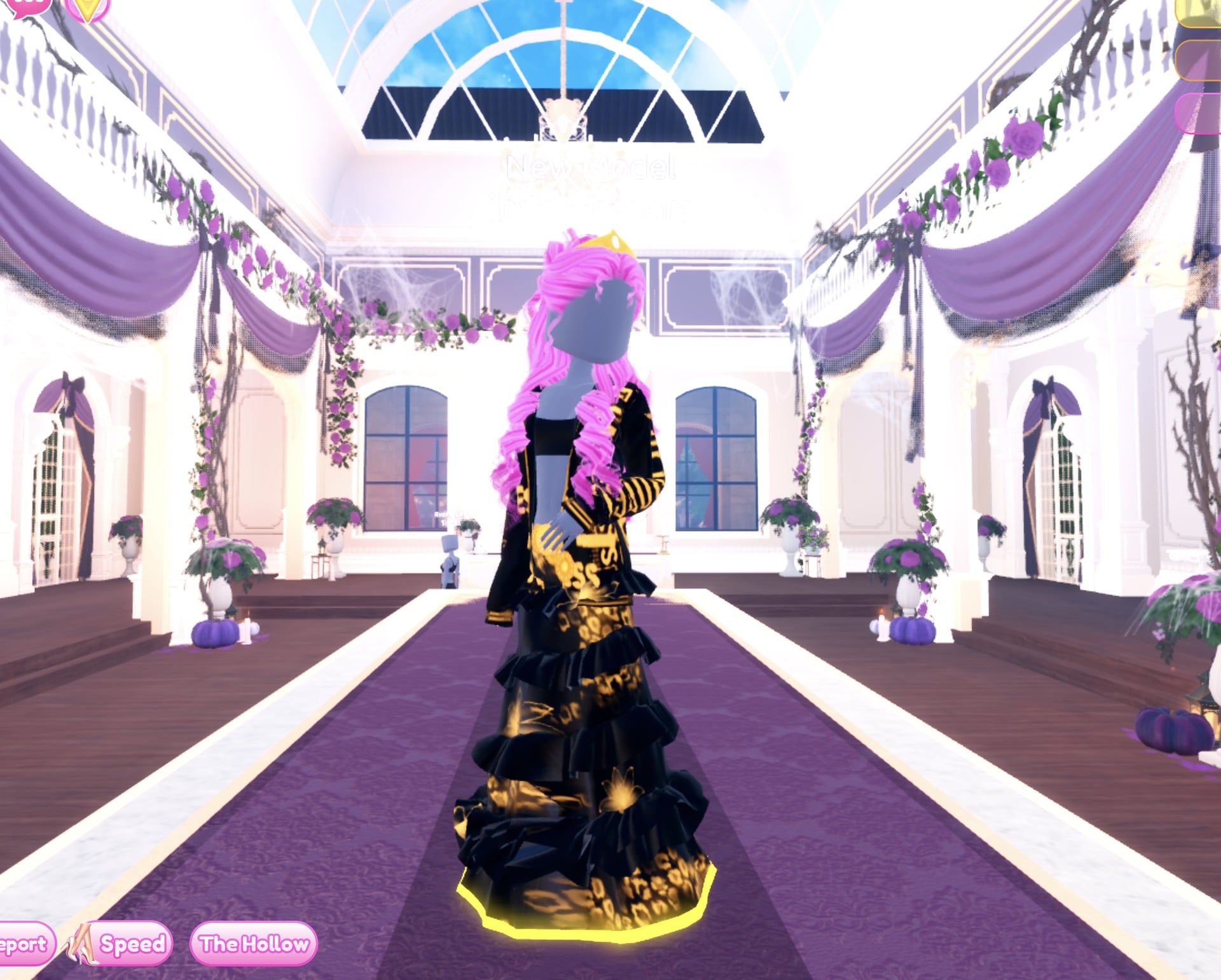 Black and gold Drag look on the Freeplay Runway: black ruffled gown with gold print and a glowing gold hem, black jacket with gold lettering, pink curls and a gold crown