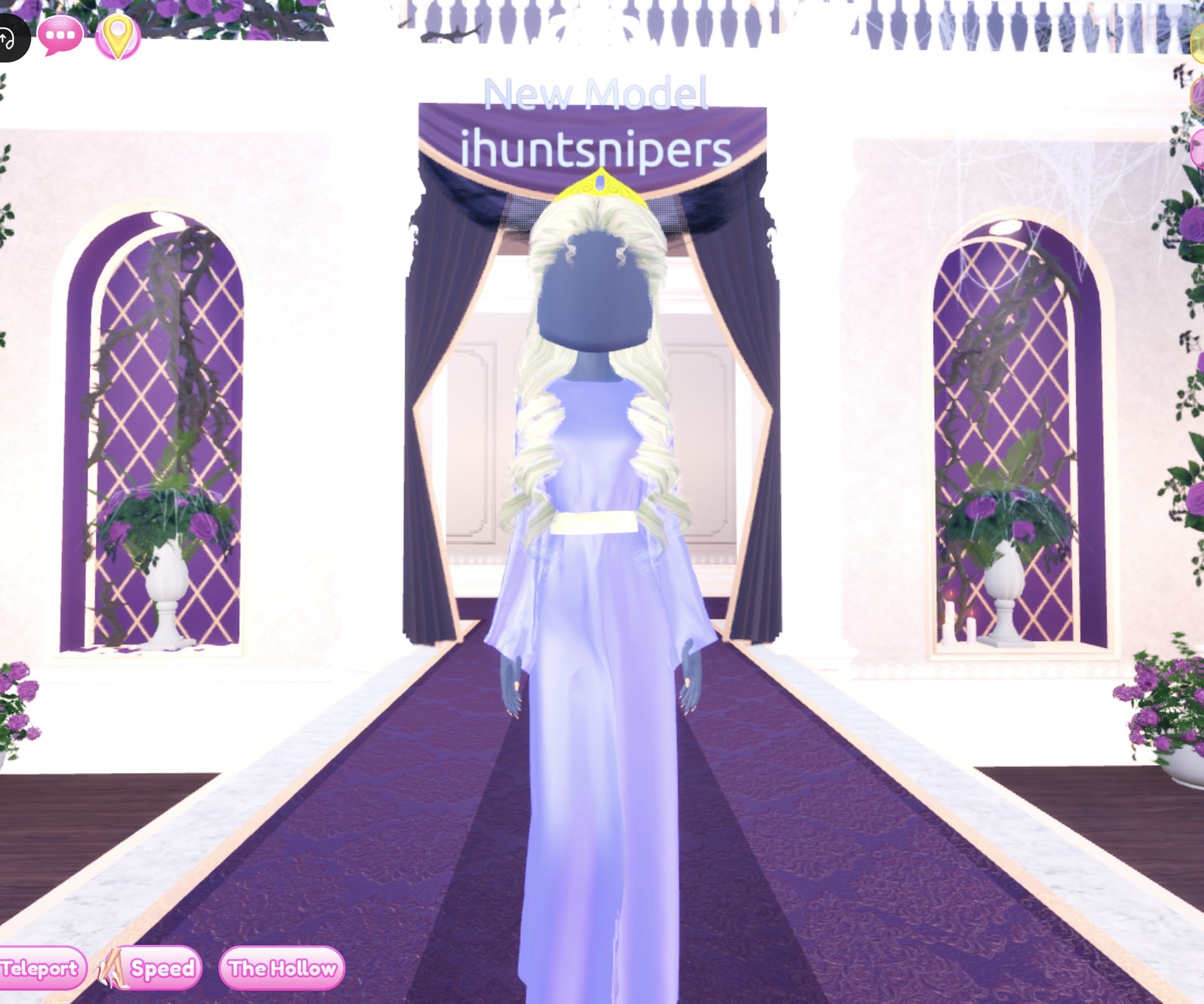 Storybook princess look from the front: lavender-blue floor-length gown with wide sleeves and a pale belt, long pale blonde curls, a small gold crown