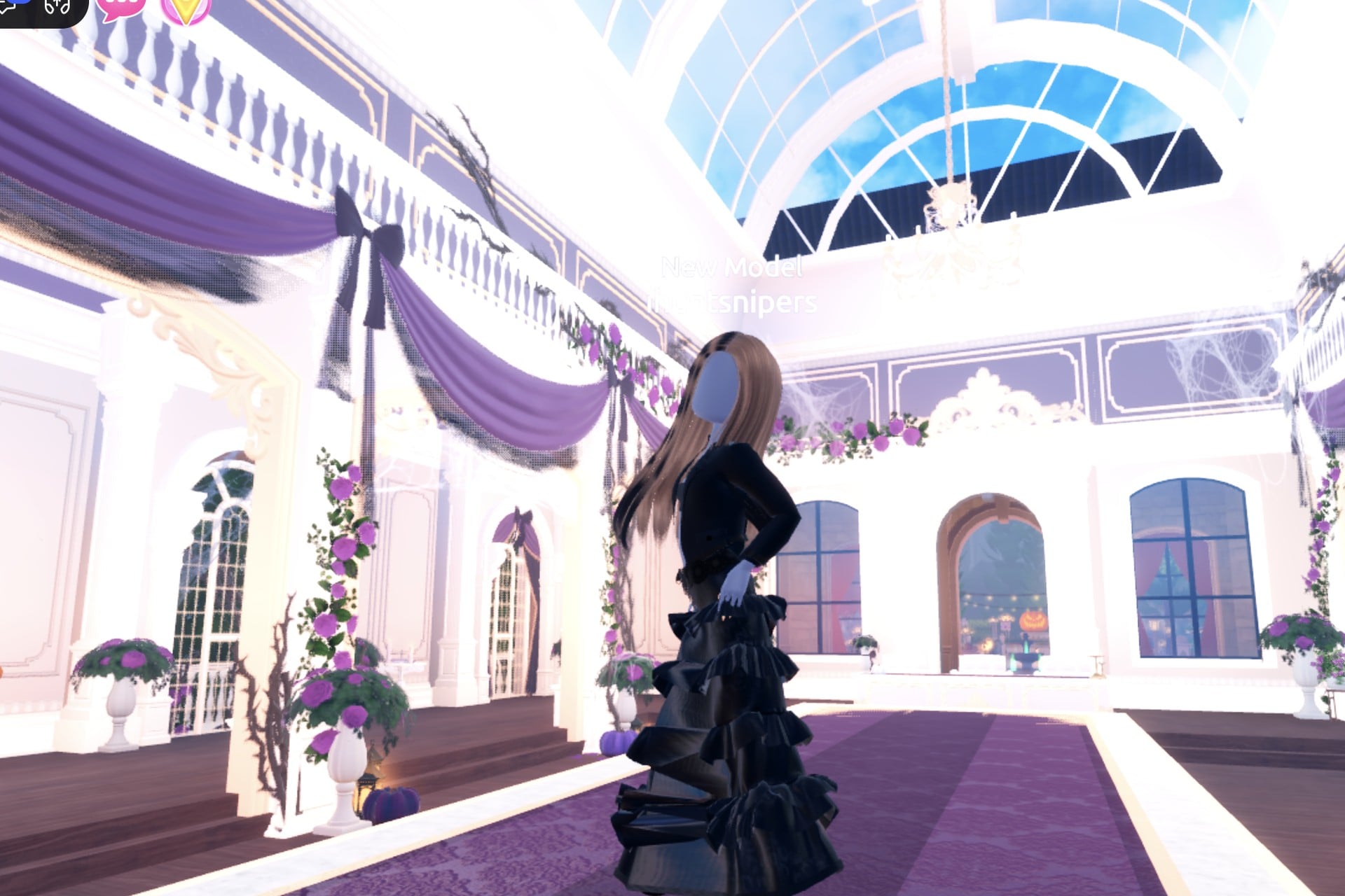All-black Monochrome Mood look in the hall: black ruffled gown, cropped black leather jacket, one hand on the hip
