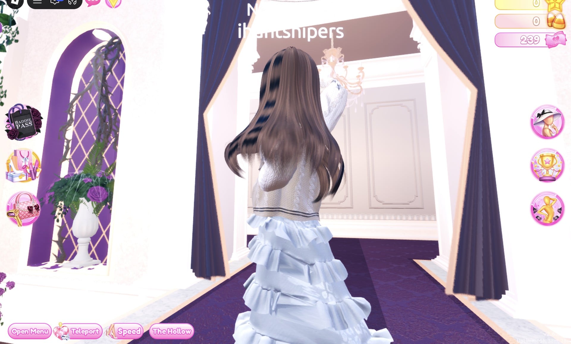 All-white look from the back: long brown hair over the cream cardigan and the white tiered gown