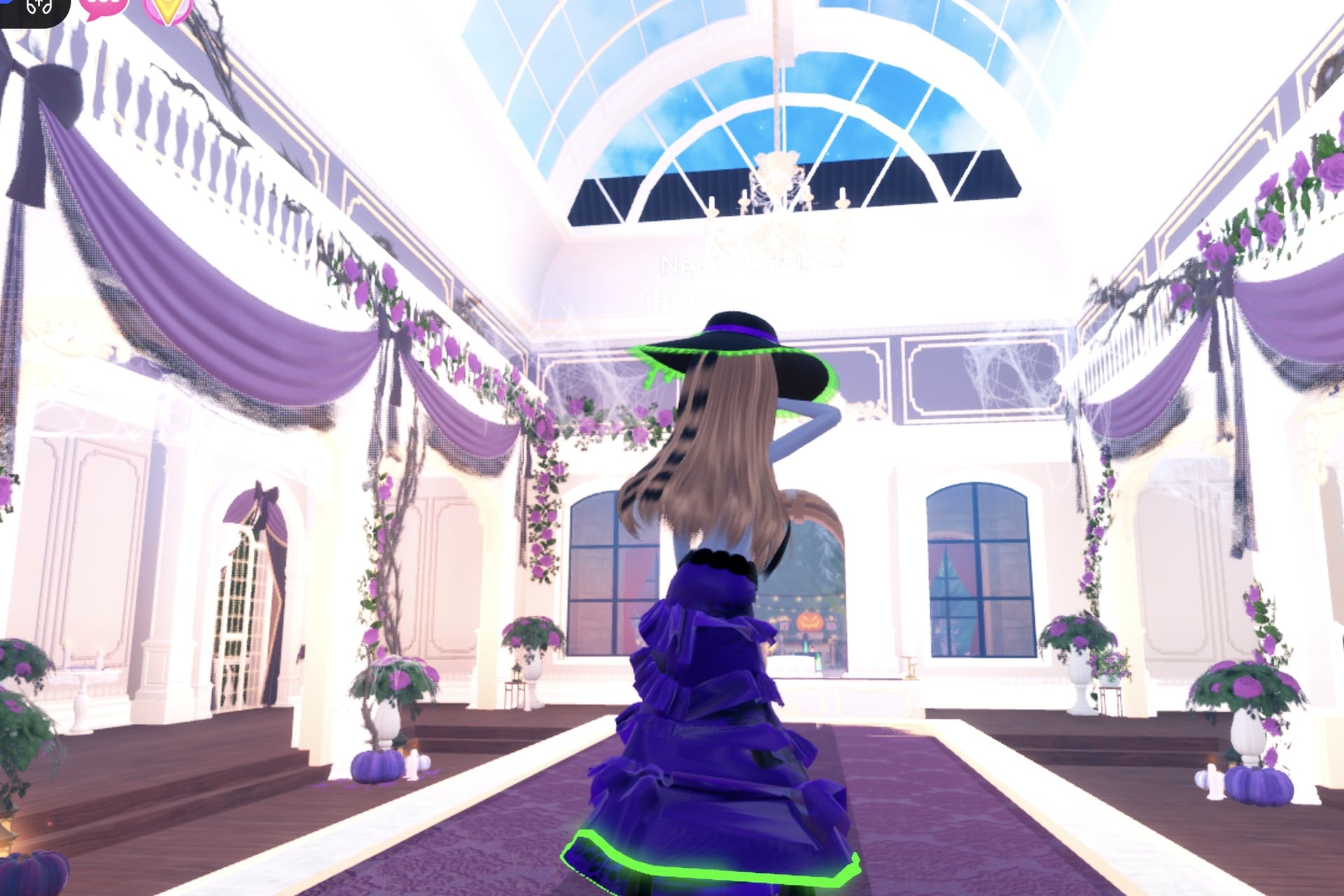 Witch brewer look from the back on the runway: long hair, purple gown, glowing green hem and hat edge