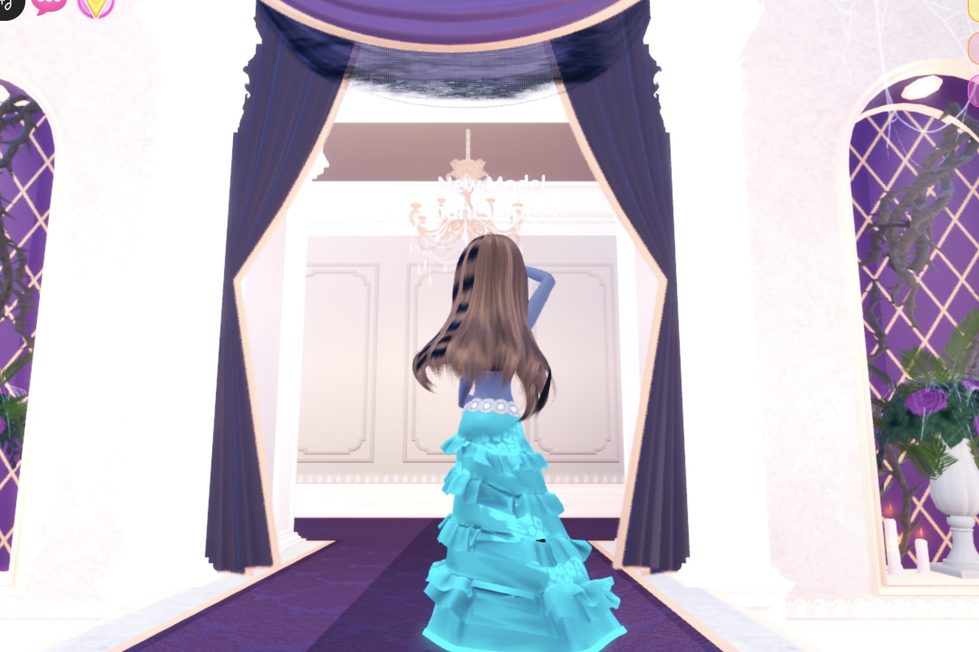 Glowing potion look from the back: long hair over the turquoise gown with its glowing cyan hem