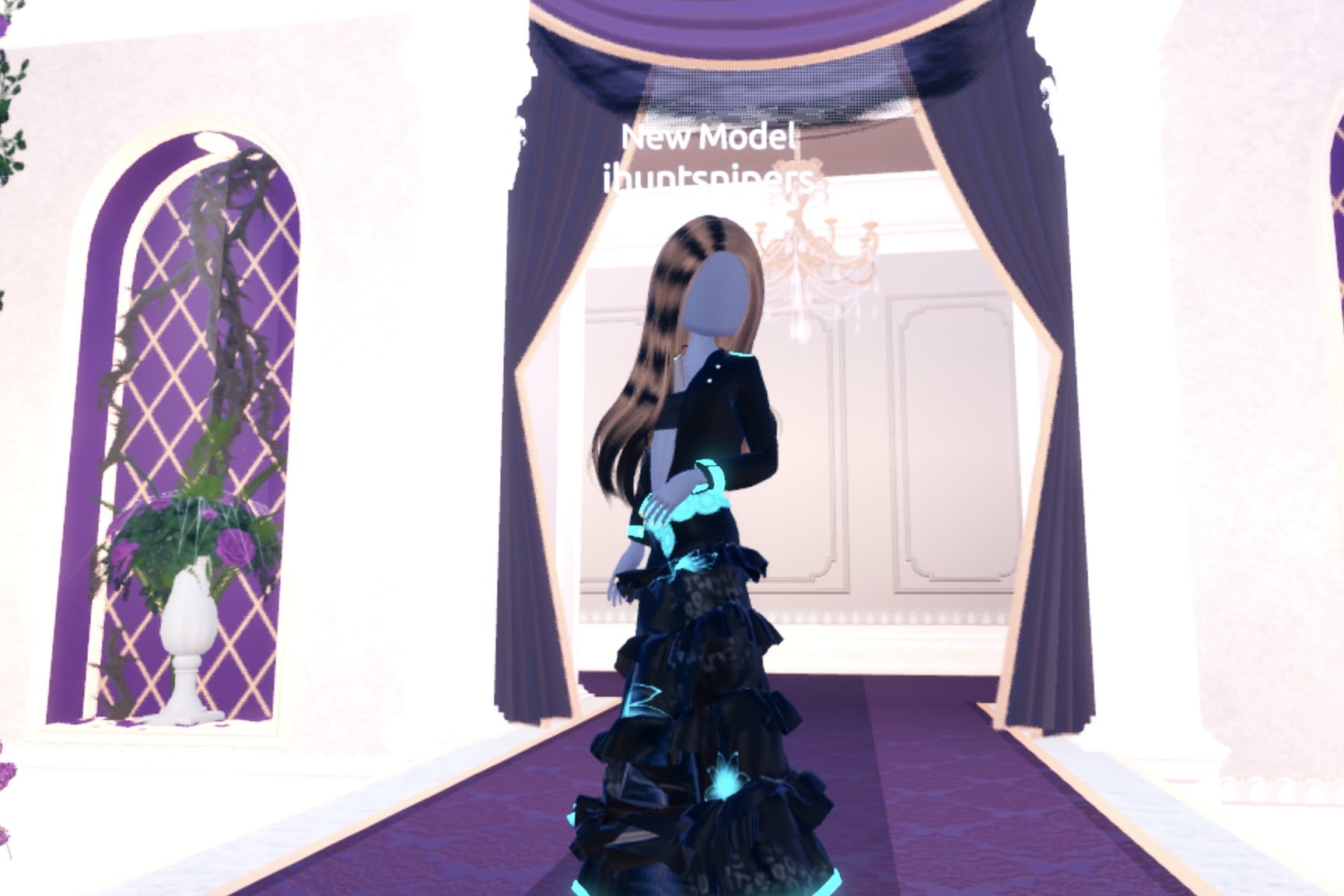 Front view of the black chrome cyborg look on the Freeplay Runway: black jacket, black tiered gown, cyan neon hem and flowers