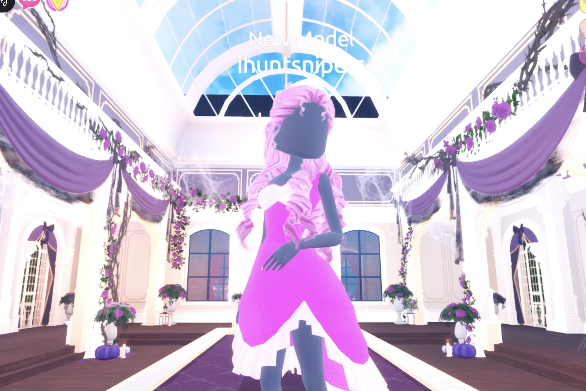 The hot pink look in the Dazzle pose on the Freeplay Runway, one hand raised at the face