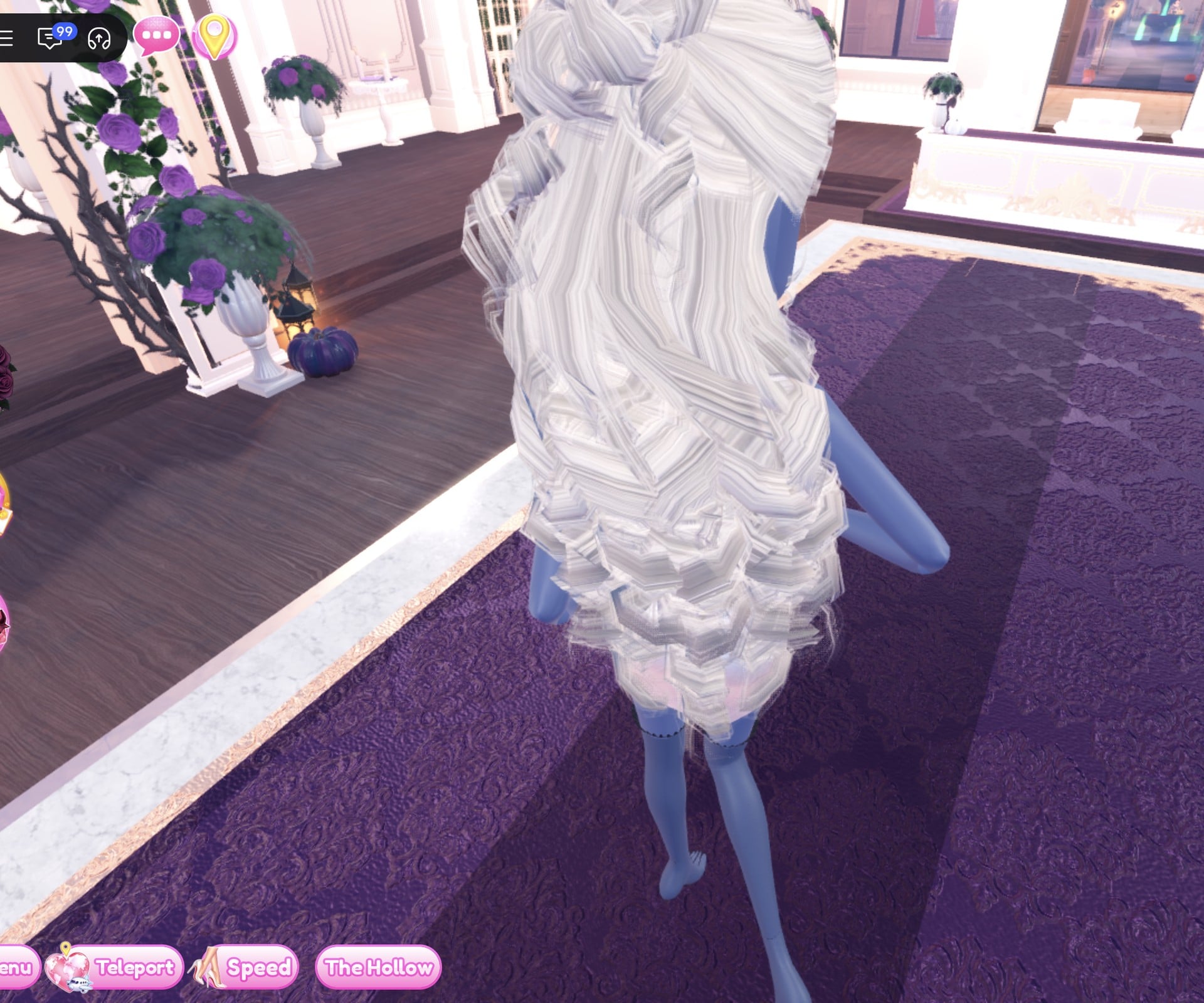 White look from behind, long platinum curls over the back of the white mini, dark thigh-highs below