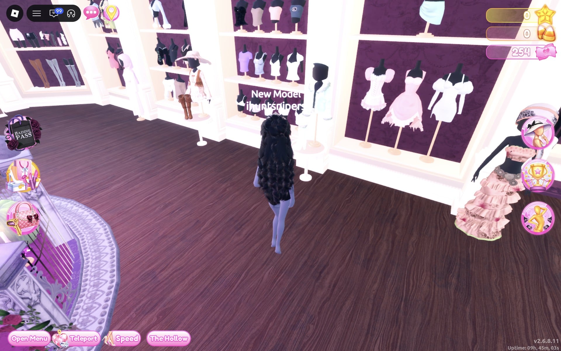 The party-dress wall with three short dresses on stands, pink ruffle, pink tiered and white, the character in front of it