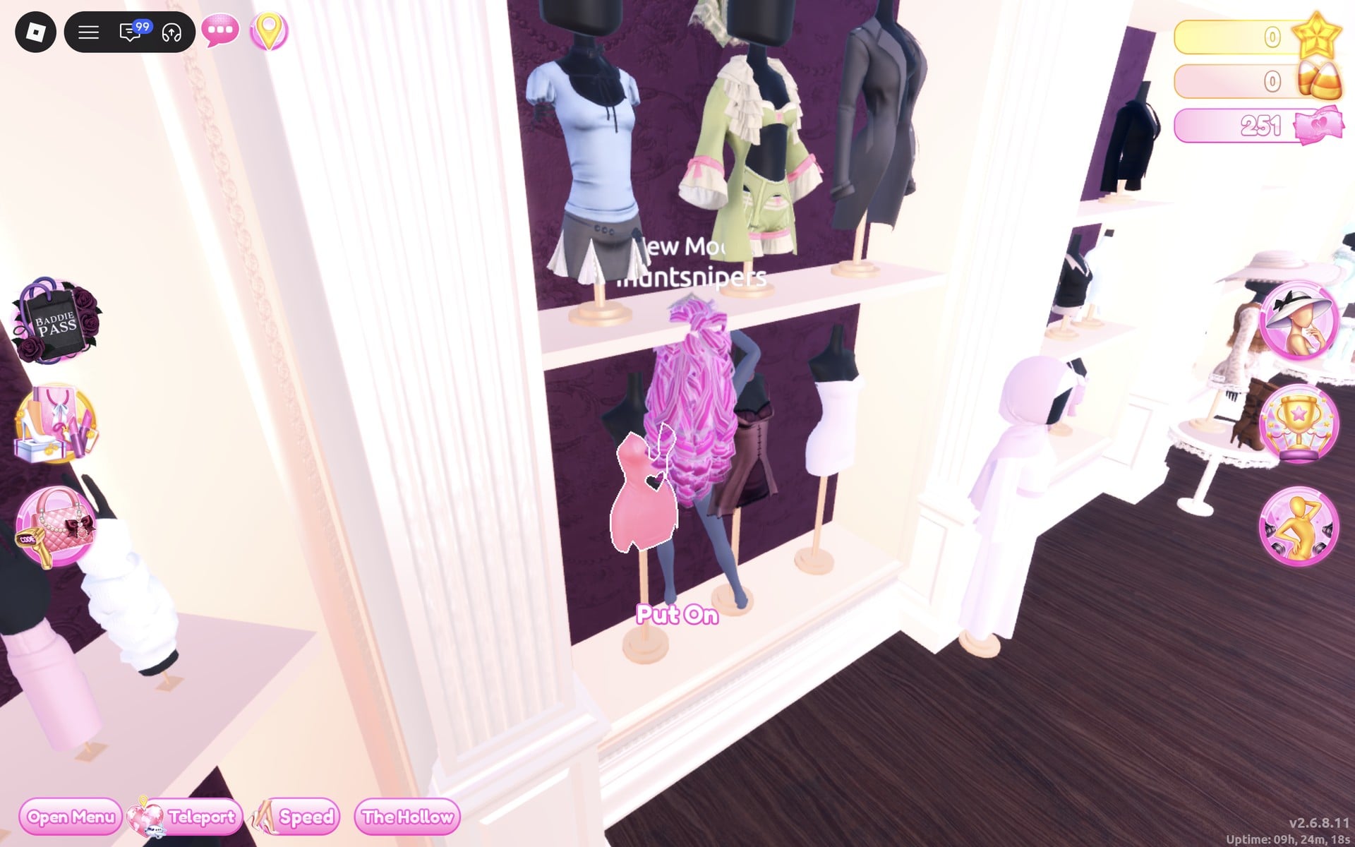 Short-dress shelf with tops above and short dresses below, and the white hooded robe on a standing mannequin to its right