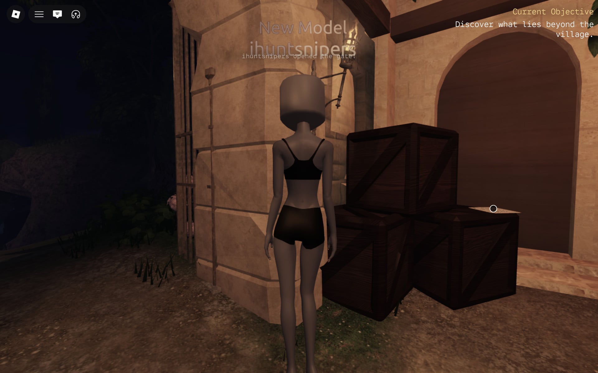 The opened village gate beside the crates, objective Discover what lies beyond the village at the top right