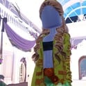 Camouflage look: olive hooded jacket over a green ruffled gown