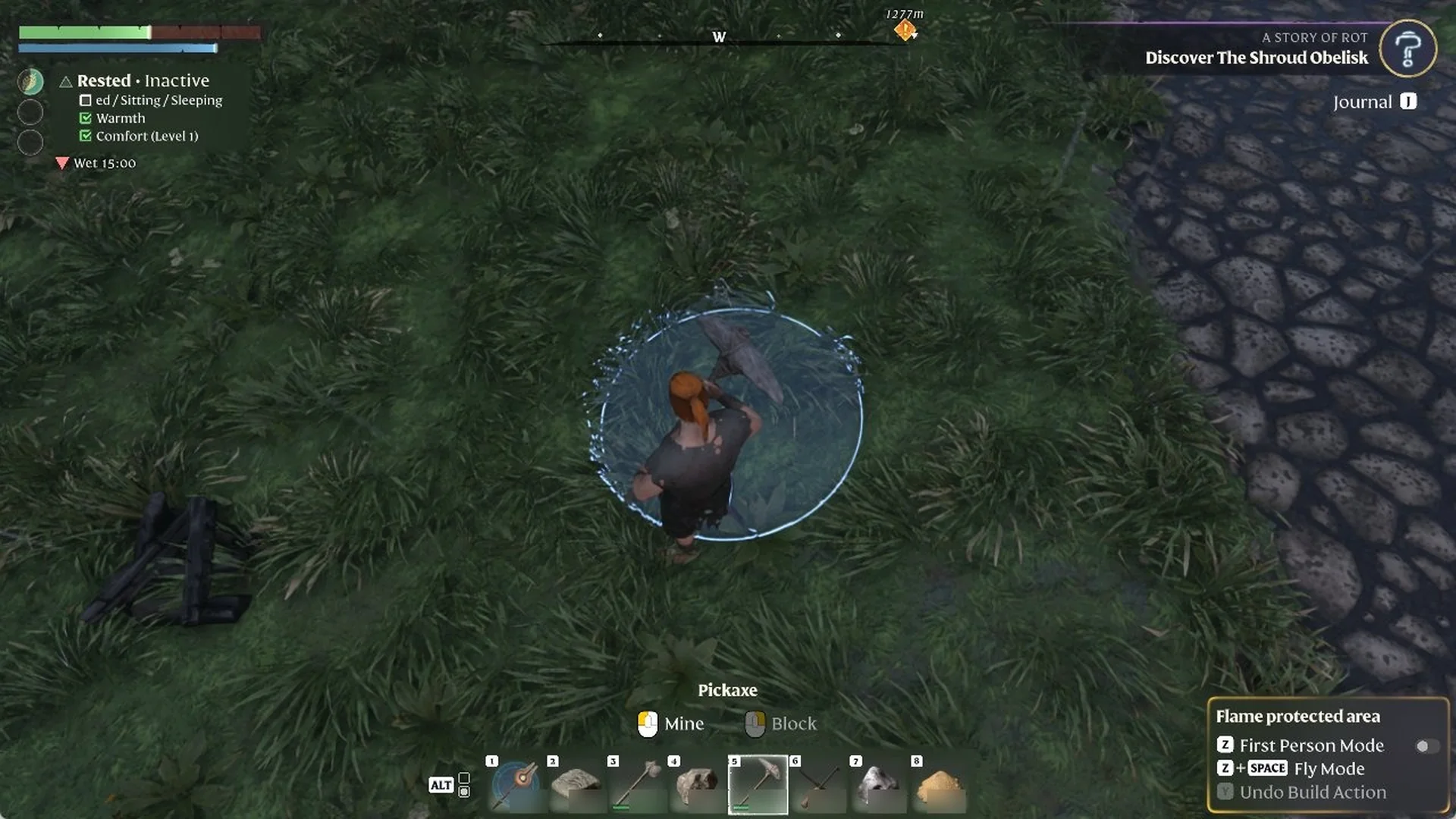 Character holding the Pickaxe on rainy grass by a cobbled road, with 'Flame protected area' shown and 'Undo Build Action' greyed out.