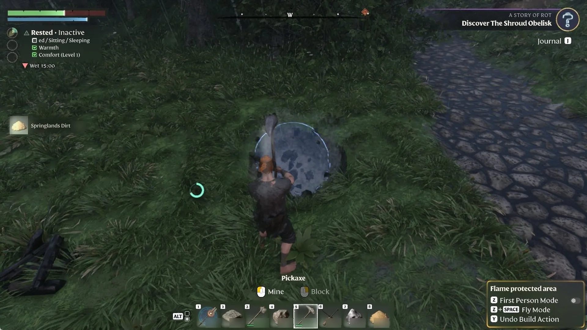 Character holding a Pickaxe beside a hole in the grass, with 'Springlands Dirt' picked up and 'Y Undo Build Action' lit
