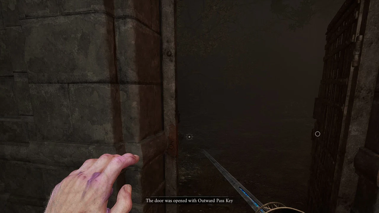 The large metal gate opened with the Outward Pass Key, dark passage beyond