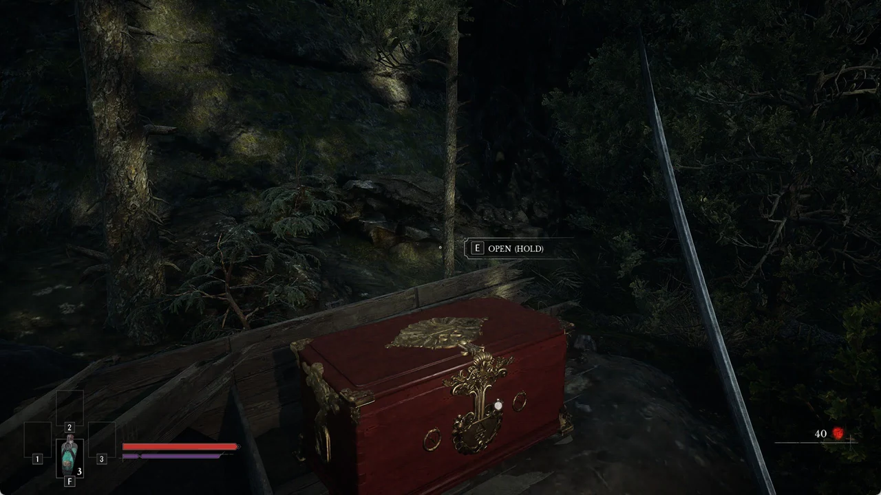 The [E] OPEN (HOLD) prompt over a red and gold chest in the woods