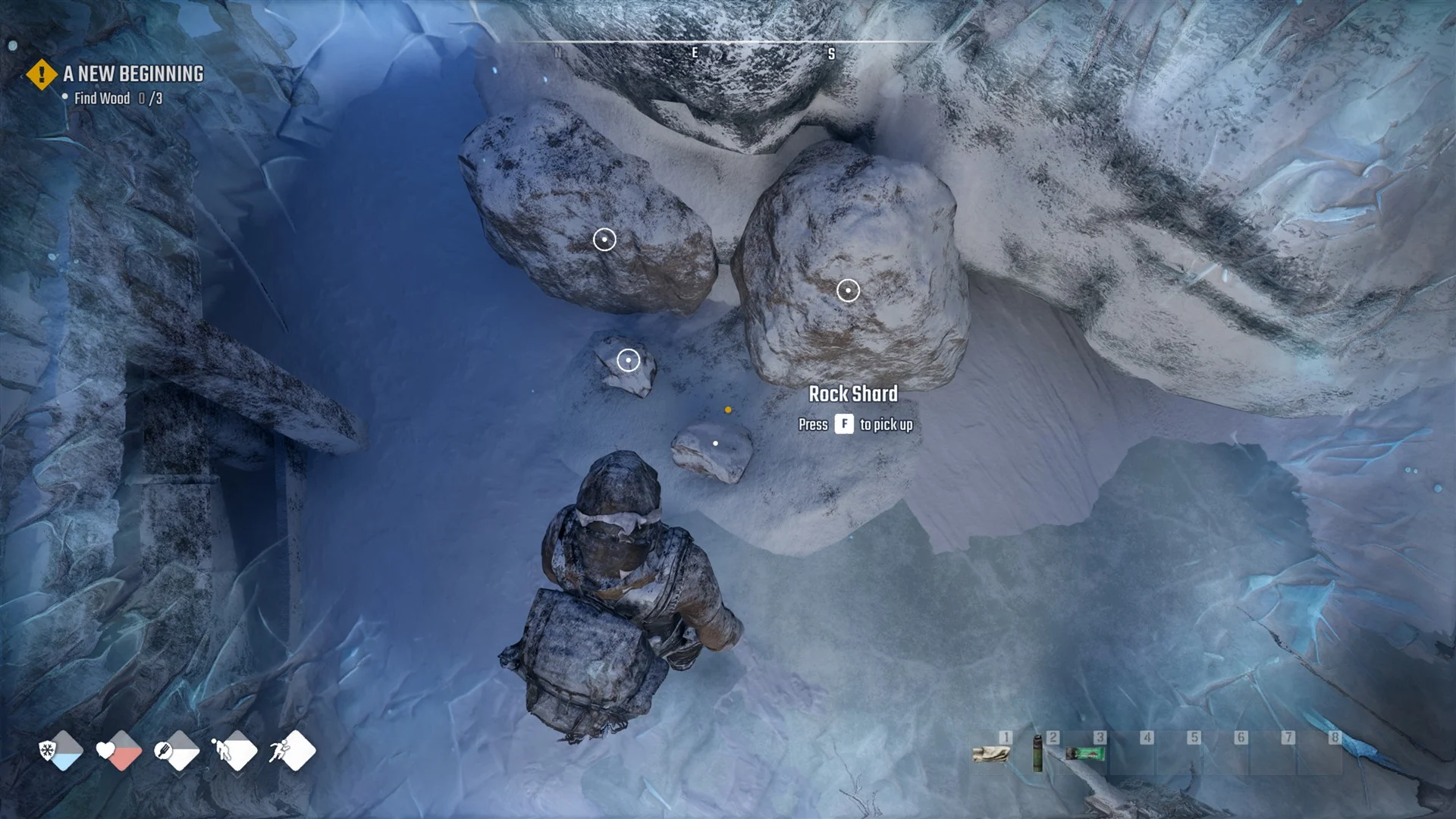Rock Shard on the snow beside two boulders with the prompt Rock Shard, Press F to pick up