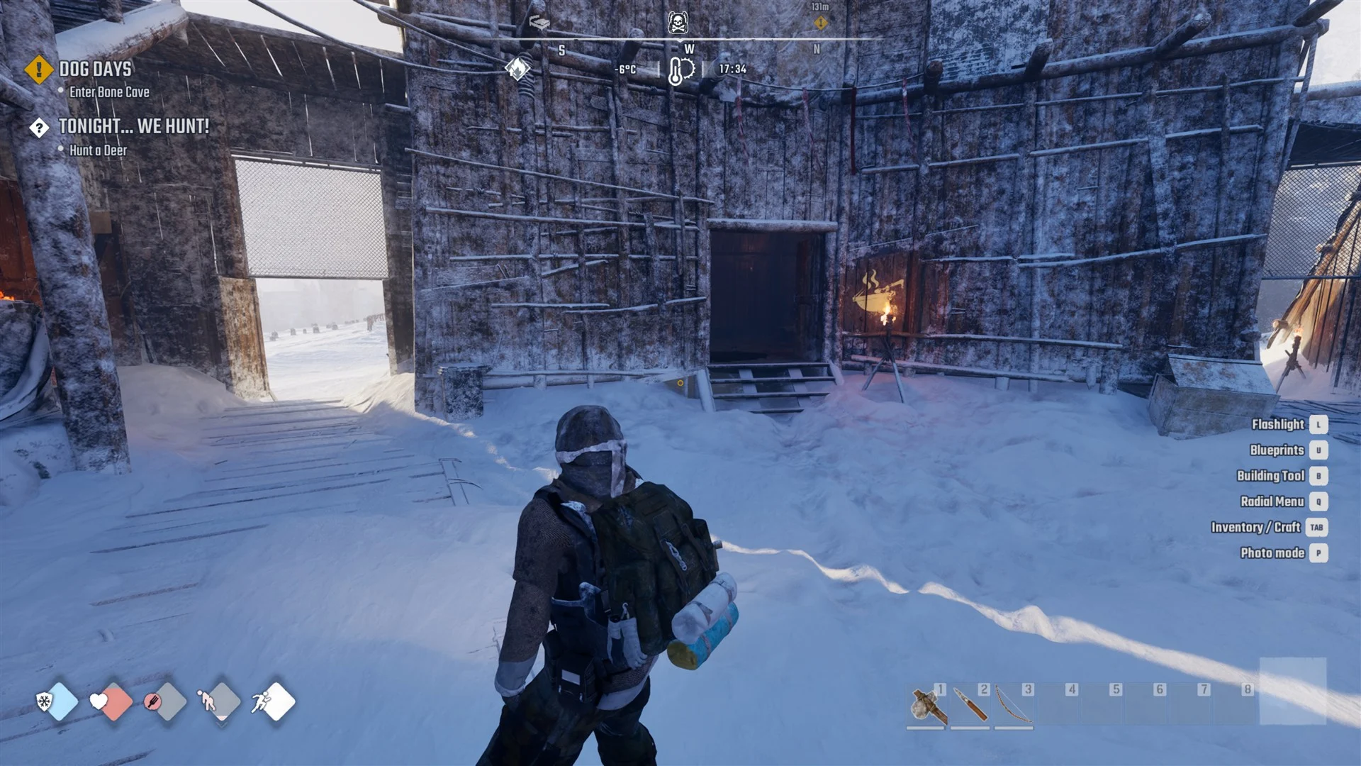 A survivor walking toward Horizon's kitchen building in the snow by day