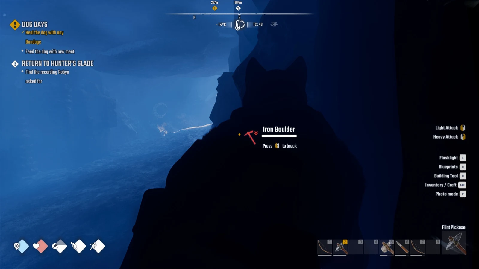Silhouetted dog in a dark blue cave faces an Iron Boulder with a Press to break prompt, quest tracker and hotbar visible.