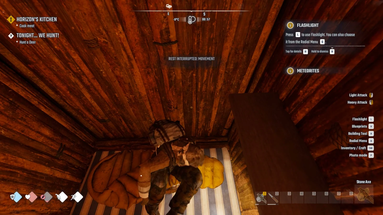 Survivor lying in a sleeping bag on a striped mattress in a log cabin, seen from above, with quest tracker and tutorial prompts.
