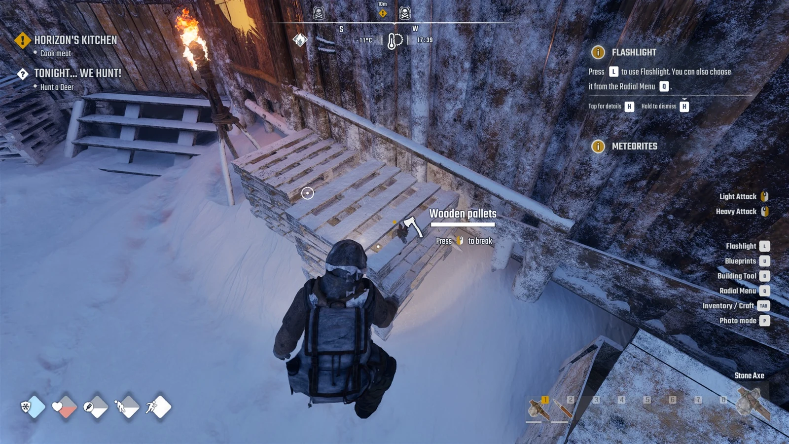 Player crouches near stacked wooden pallets in snow, with a break prompt, quest tracker, and Stone Axe in the corner.