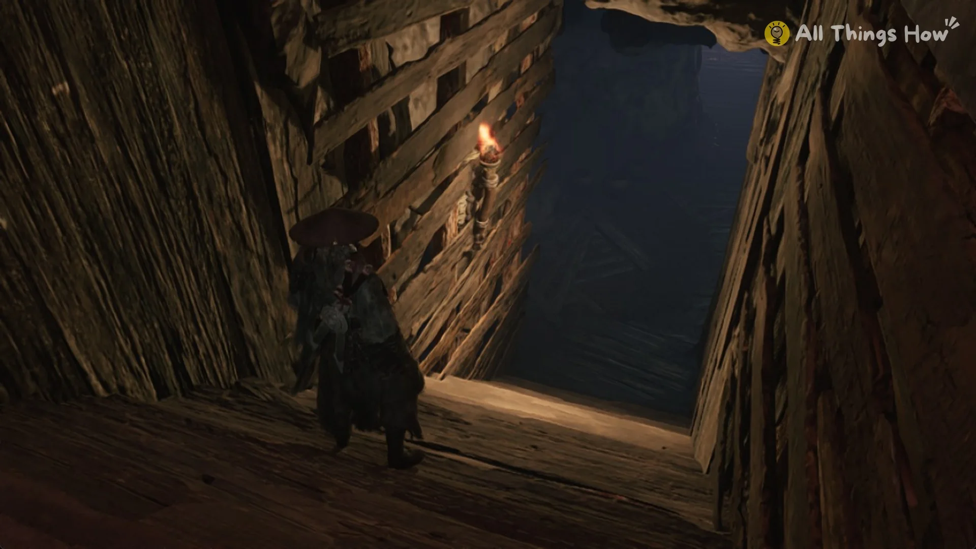 The torch-lit stairwell that opens beside the crank socket in the Crimson Forest storehouse, Phantom Blade Zero