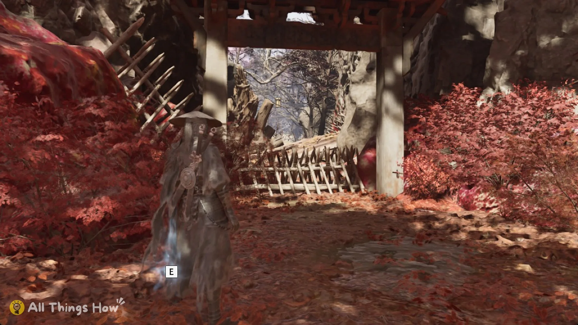 Soul in front of the stake-barricaded gateway at the Thieves' Camp with the E prompt in Phantom Blade Zero