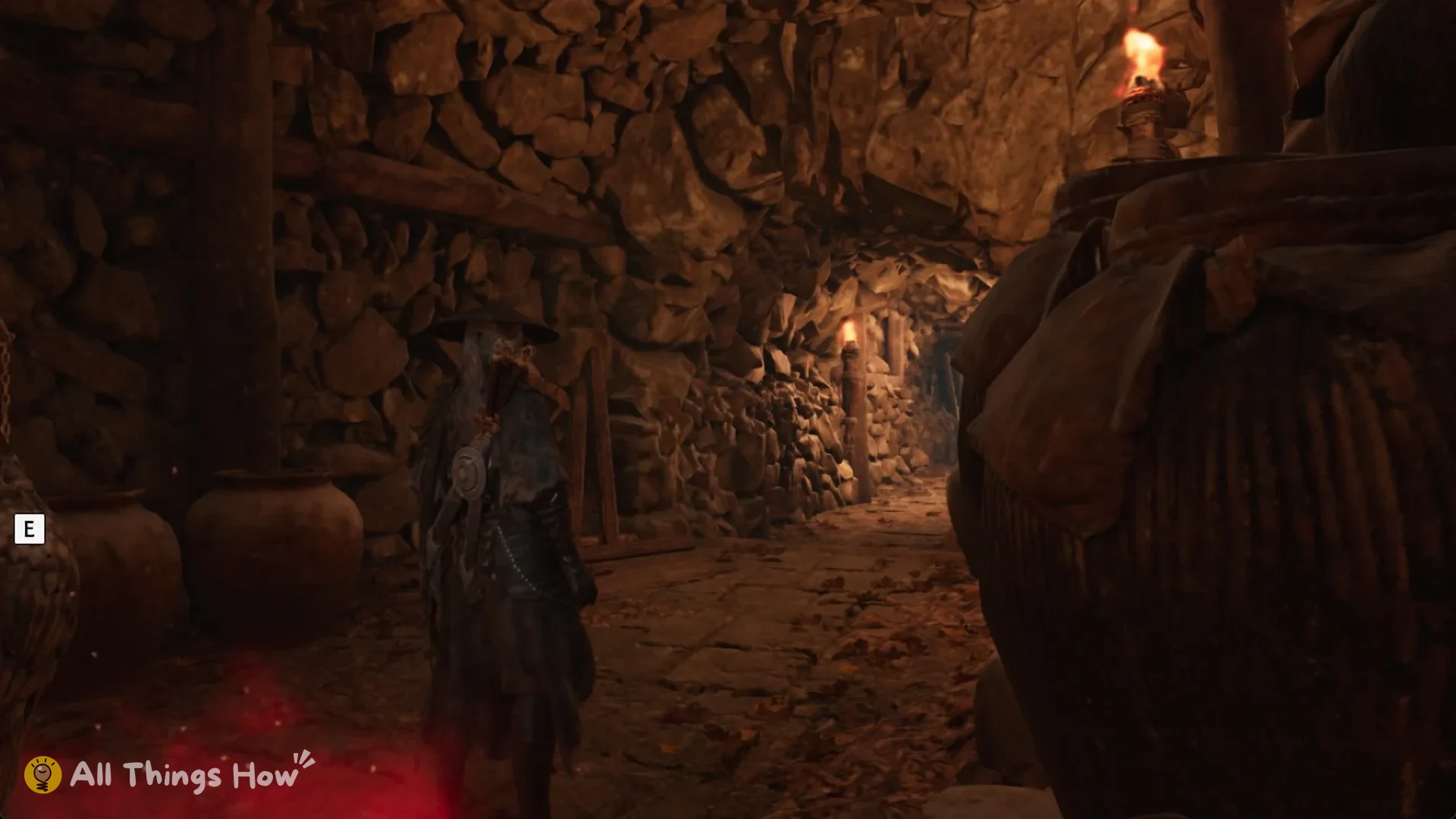 The torch-lit tunnel leading on from the Hidden Storehouse bell, Phantom Blade Zero