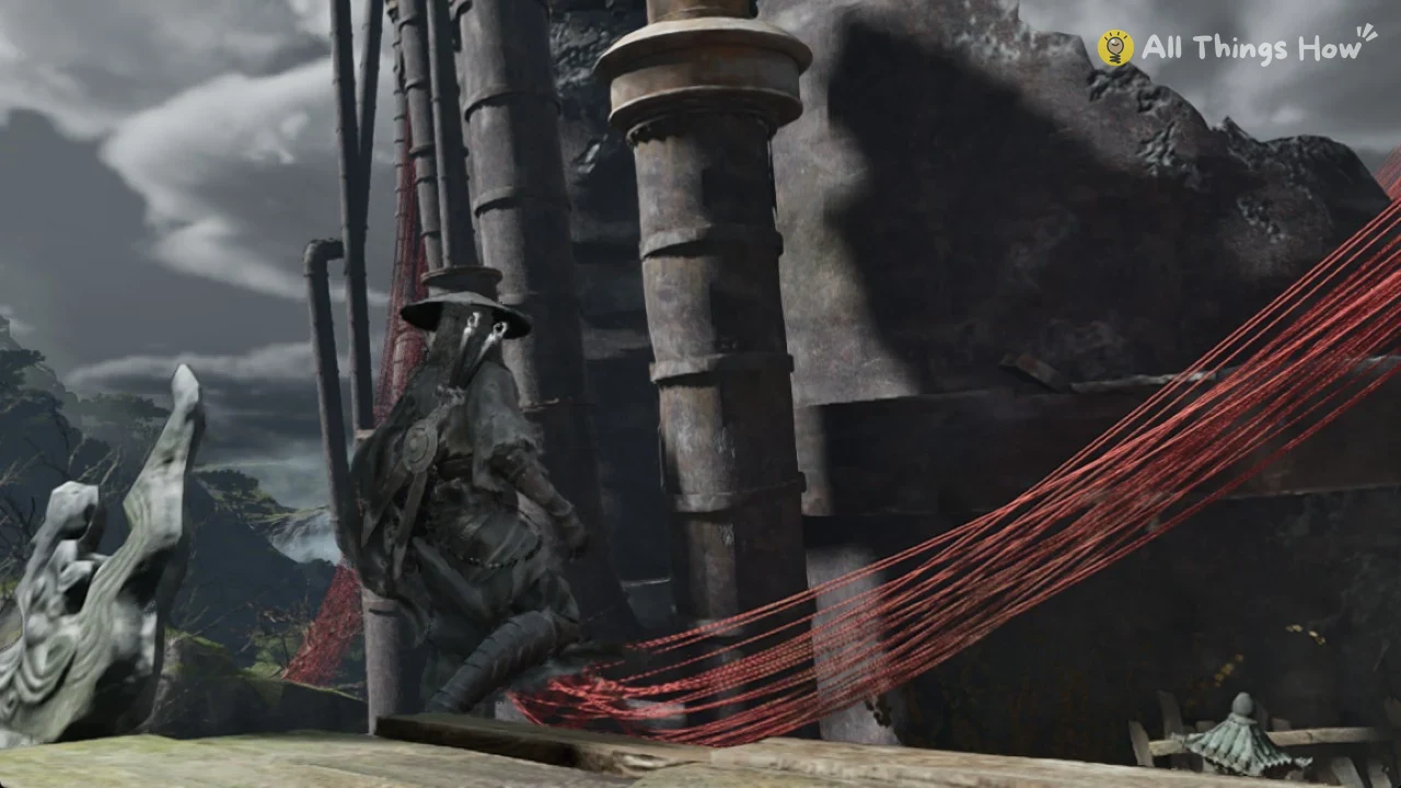 Soul in a wide straw hat beside rusted pipes, red threads stretched across, a stone carving and cloudy sky behind.