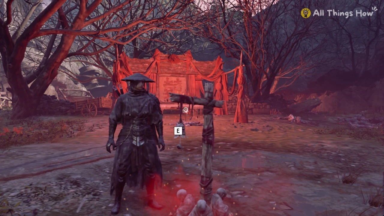 Soul in a wide straw hat beside a bell on a wooden post, with a red-draped altar among bare trees behind.