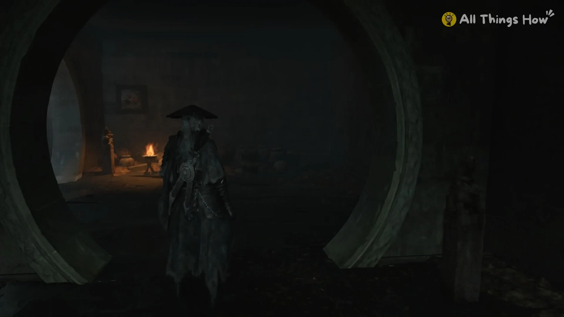 A round moon gate in the dark brazier room under the pavilion, with braziers burning beyond it