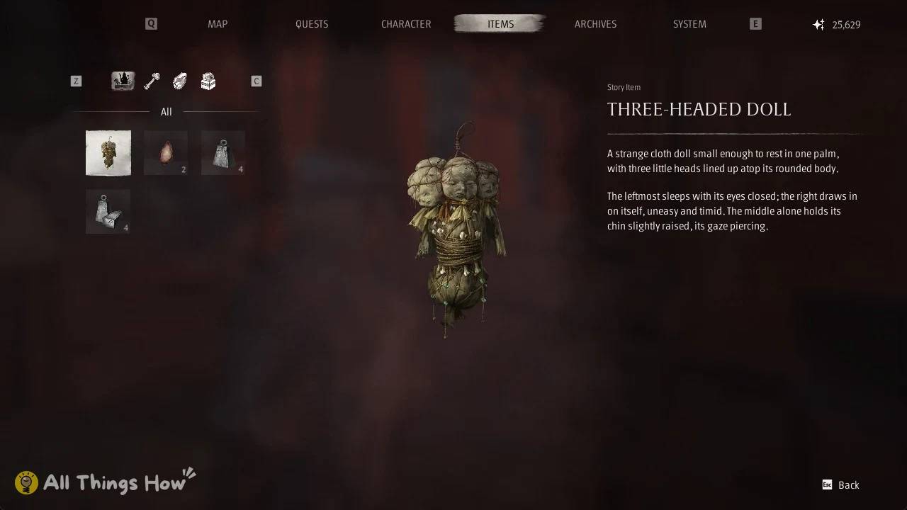 Items menu showing a cloth doll with three small heads and a text description on the right.