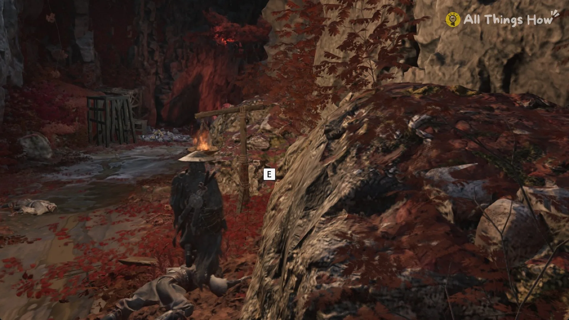 Stream path with a wooden cage and lantern post below the rock in Crimson Forest in Phantom Blade Zero