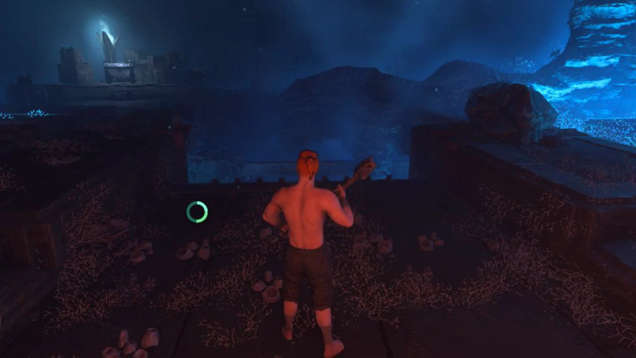Shirtless character holding a tool and facing a drop in a dark, blue-lit cavern