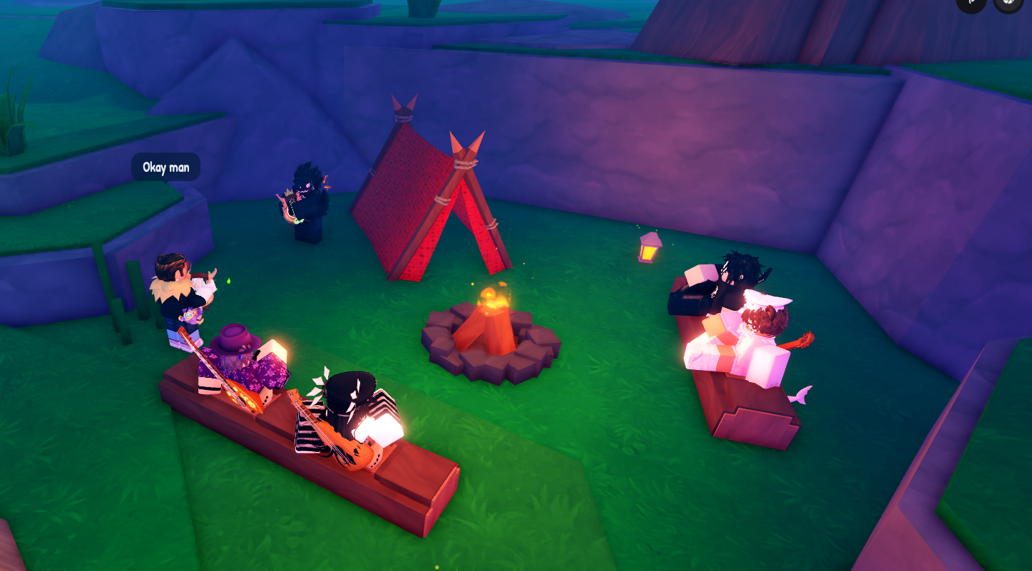 Several game characters are gathered around a campfire at night, with a tent, benches, and a lantern nearby