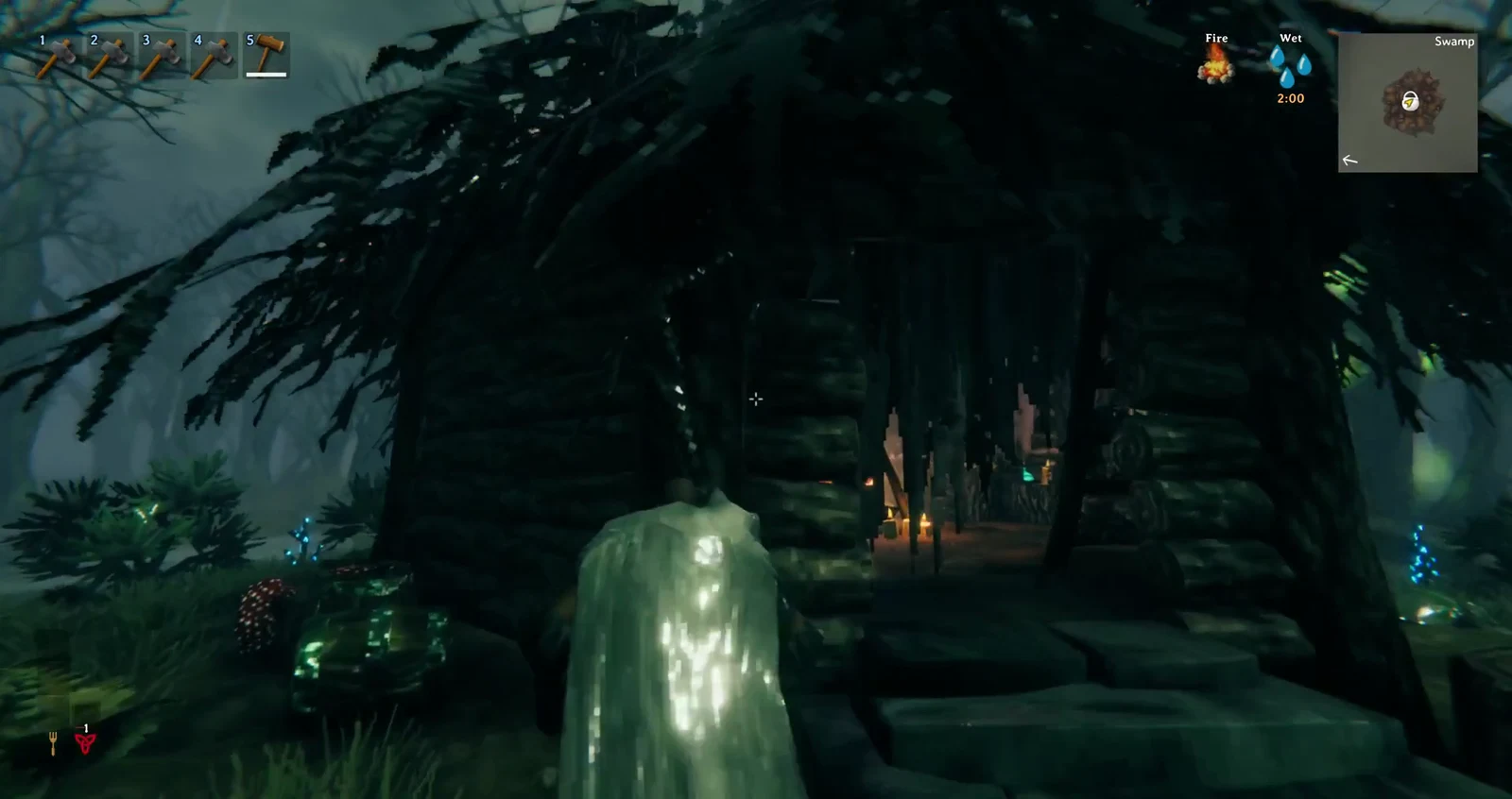 Aiming the crosshair into the hut's open dark wooden entrance with the Wet status active