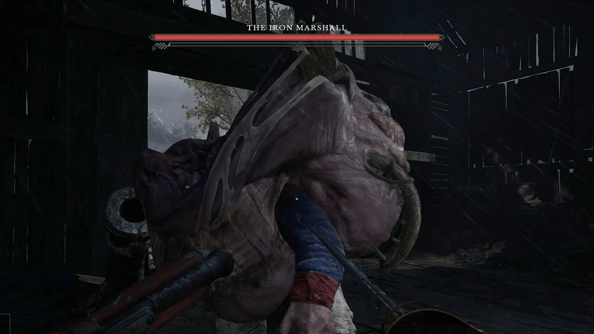 The Iron Marshall, a hunched plague giant with a blue sleeve and a cannon arm, inside a dark barn