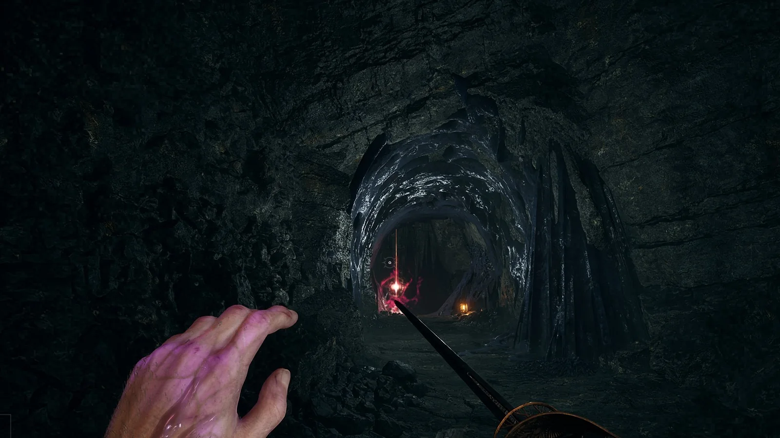 A red pillar of light glowing at the far end of a dark mine tunnel