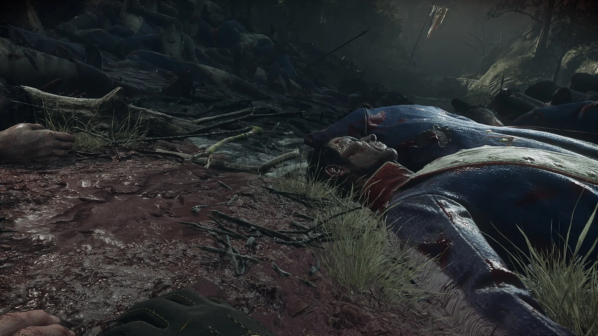 A fallen French soldier lying in the grass of the forest ravine on the Valor Mortis battlefield
