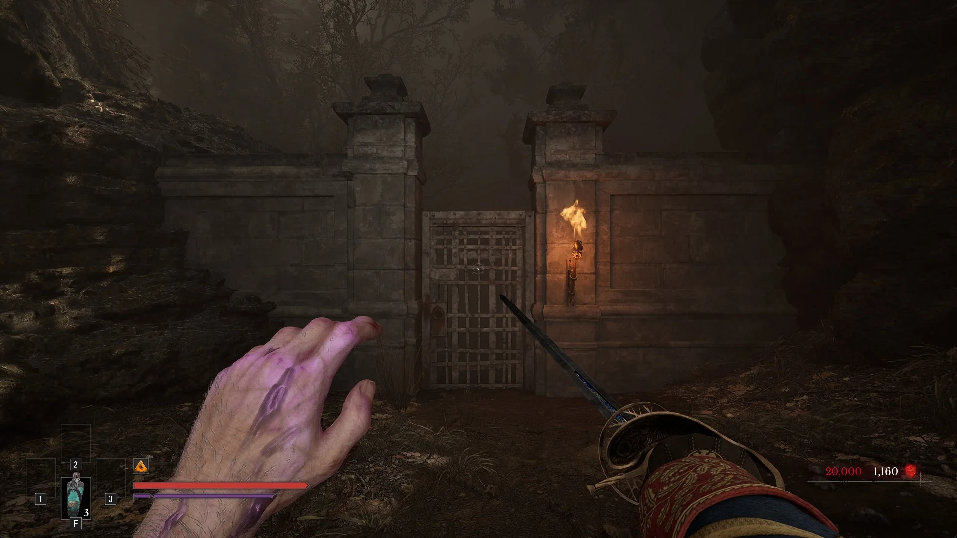 The Outward Pass Gate, an iron grille between two stone pillars with a torch