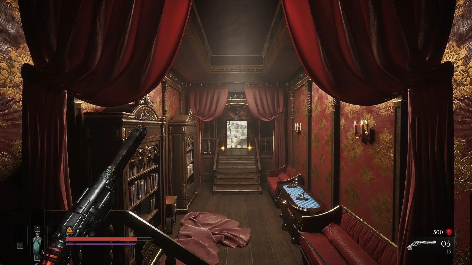 Red velvet salon inside the wagon with bookcases, red sofas, curtains and a staircase at the back