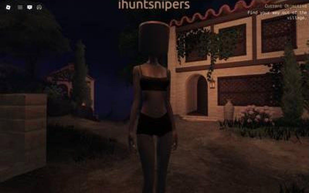 Avatar standing in the dark village street outside the stone house that holds the Gate Key