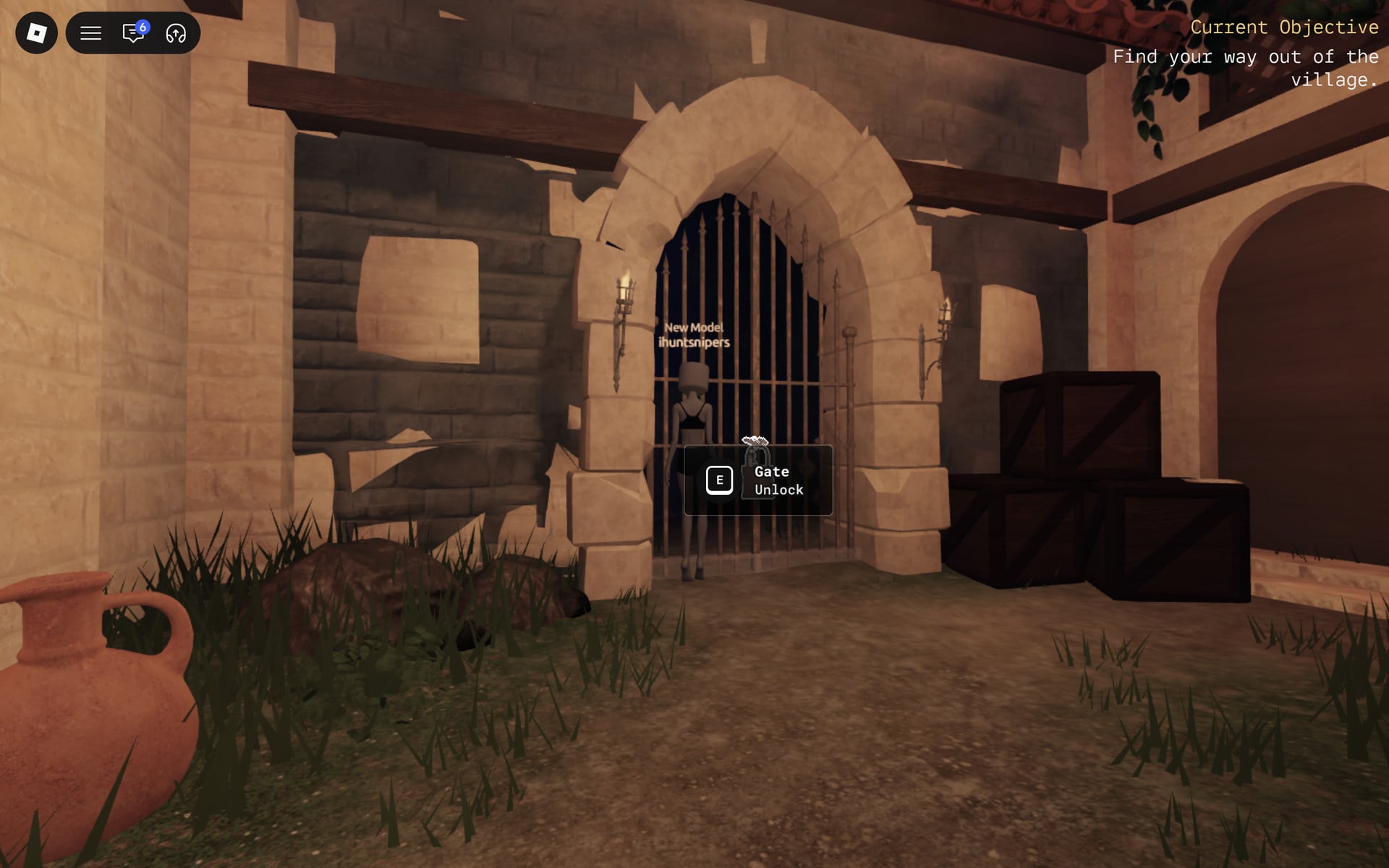 Iron barred village gate under a lit stone arch with the Gate Unlock prompt